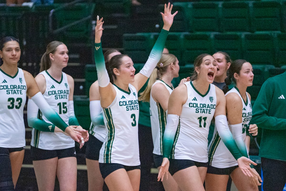 Players on the Colorado State University volleyball team celebrate after their teammate scored two service aces in a row during the third set of the Rams' game against Oregon State University in Moby Arena Oct. 10.