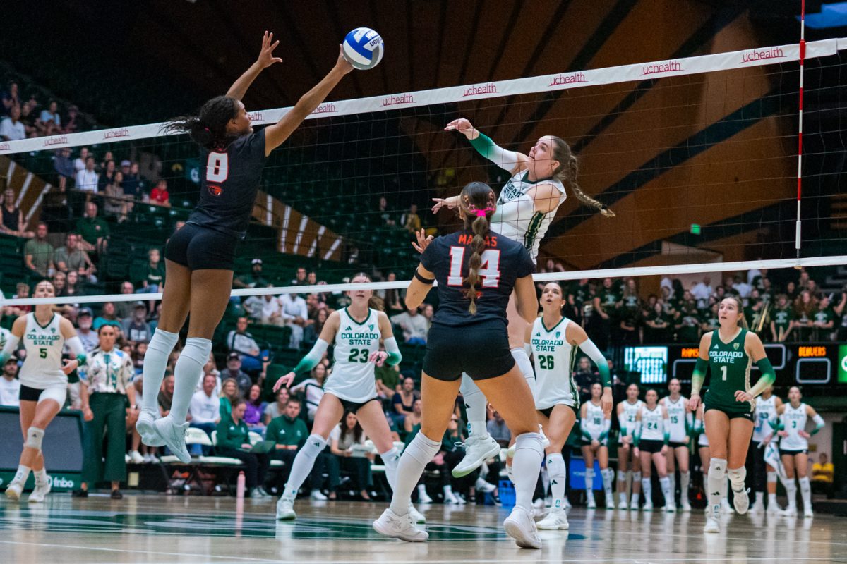 Colorado State University middle blocker Eve Wilson (27) spikes the ball past the hands of the Oregon State University defense to score a point for the Rams during a home volleyball match Oct. 10. Wilson scored 16.2% of the Rams' 99 points over four sets, leading CSU to a 3-1 win.