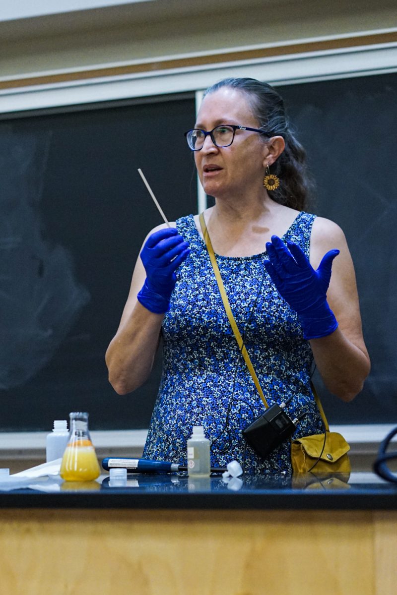 Ruth Tucker, a master instructor at Colorado State University, holds a wooden skewer while narrating her actions for an in-class demonstration in the Chemistry building Oct. 1.