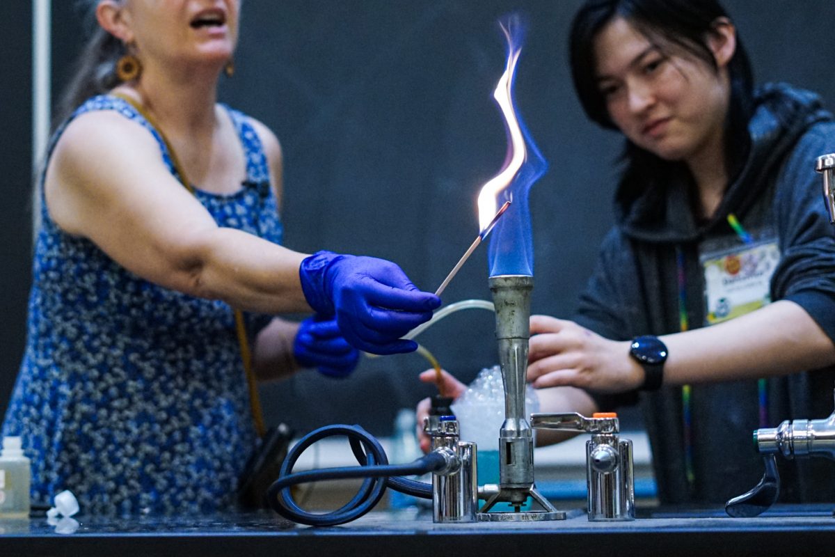 Ruth Tucker, a master instructor at Colorado State University, holds a wooden skewer to the flame of a Bunsen burner as part of an in-class demonstration in the Chemistry building Oct. 1.