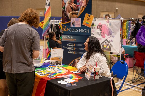 A volunteer talks to event attendees during Northern Colorado Pride 2026 Oct. 4. 