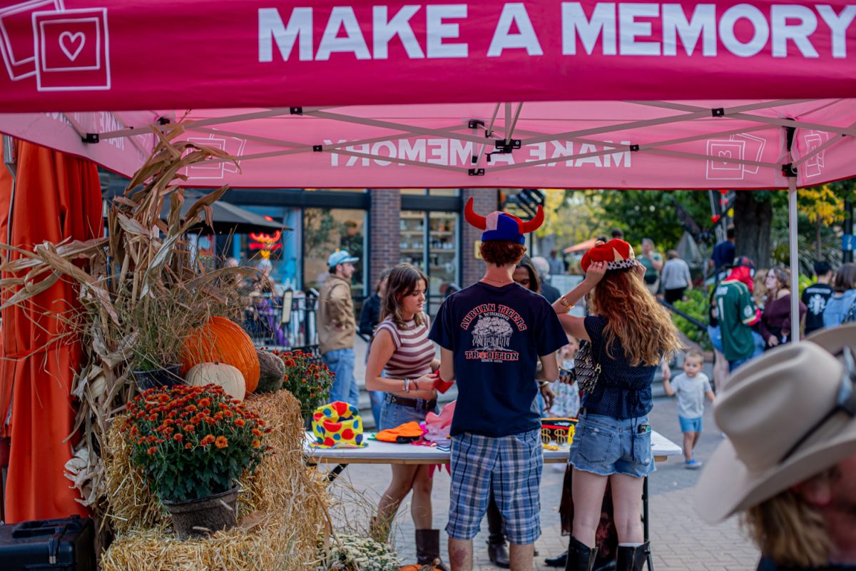 Event attendees try on hats at FoCo Fall Fest Oct. 9.