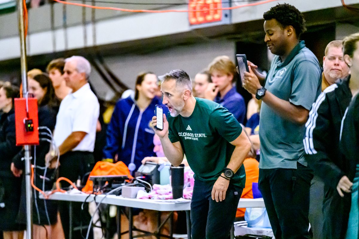 Colorado State University swim and dive head coach Christopher Woodard cheers on CSU swimmers competing in the fourth heat of the 200 yard butterfly Oct. 2.