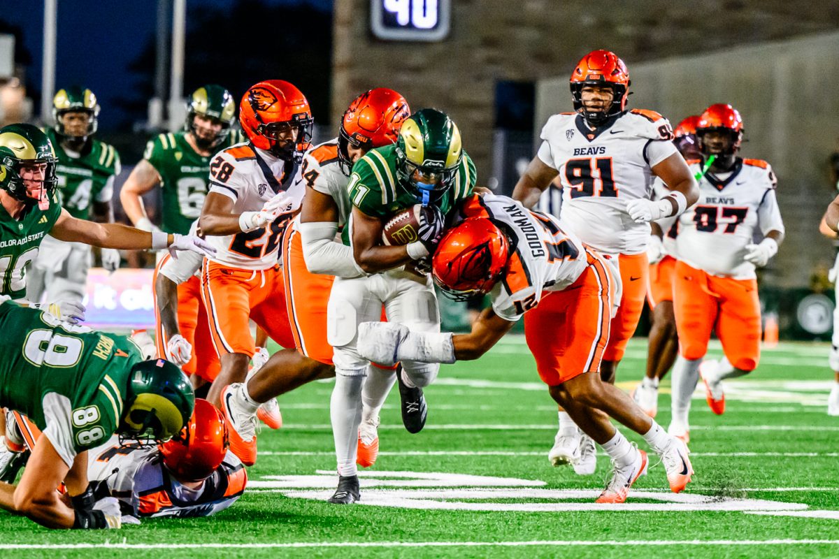 Colorado State University running back Durell Robinson (11) forces his way through Oregon State University defensive players during CSU's Homecoming game against OSU Oct. 3.