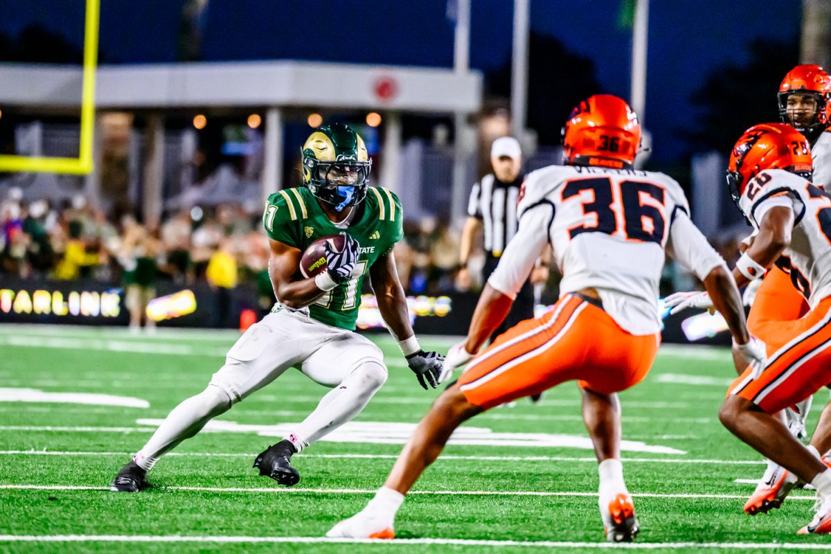 Colorado State University running back Durell Robinson (11) fakes left around Oregon State University defensive players during CSU's Homecoming game against OSU Oct. 3. 