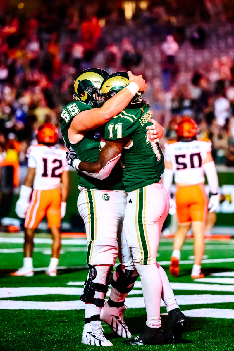 Colorado State University offensive lineman Phillip Ocon (65) hugs running back Durell Robinson (11) after Robinson's fourth-quarter touchdown against Oregon State University Oct. 3. Robinson's touchdown came with 10:41 left on the clock in the fourth quarter and was one of four for the Rams.