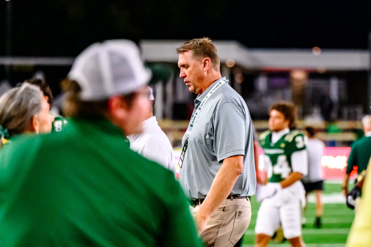 Colorado State University Director of Athletics John Weber walks off the field with the CSU football team after CSU's Homecoming loss to Oregon State University Oct. 3. CSU lost 56-26.