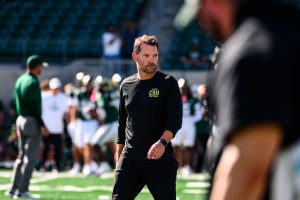 Former Colorado State University football defensive coordinator Tyson Summers works with players during warm ups for CSU's Homecoming game against Oregon State University Oct. 3.