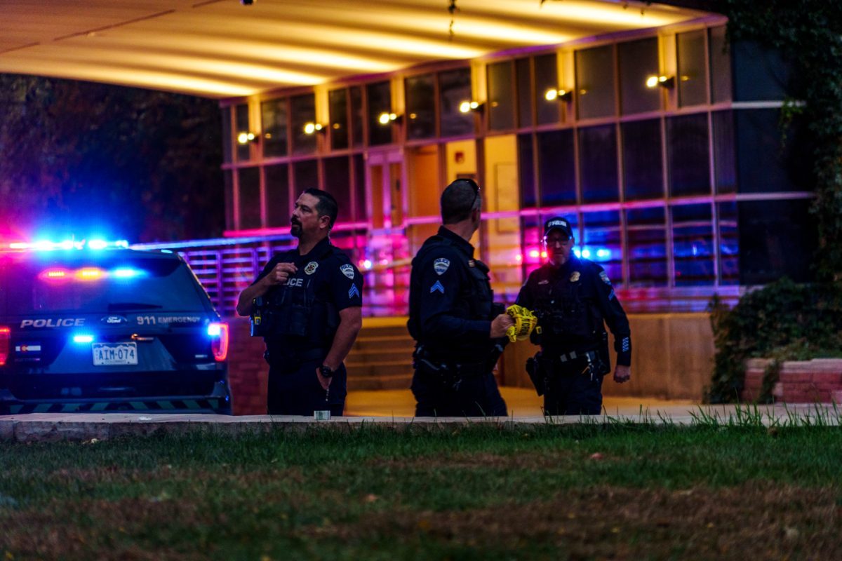 Fort Collins Police Services officers prepare to expand the barrier tape around the Colorado State University Microbiology and Chemistry Buildings after an officer-involved shooting Oct. 12.