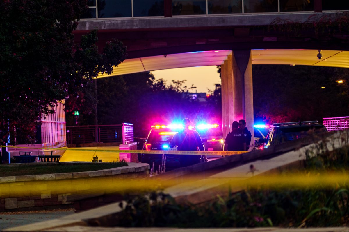 Fort Collins Police Services officers and cars sit under the Colorado State University Yates Hall bridge after an officer involved shooting in the Microbiology Building Oct. 12. 