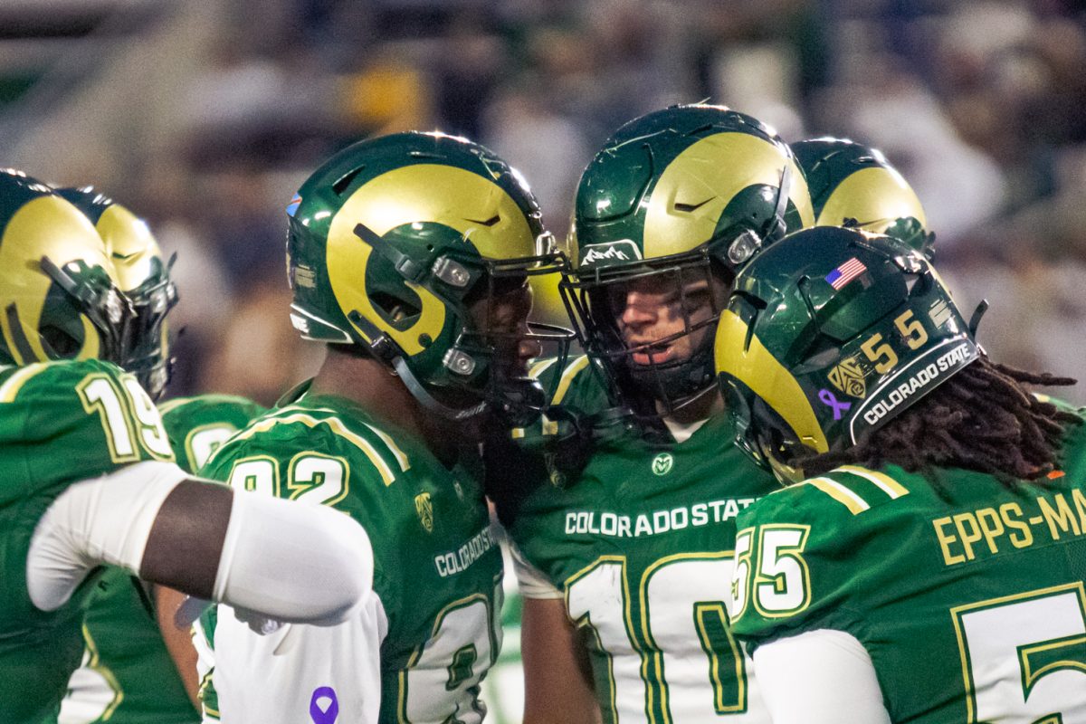 Colorado State University football players celebrate with wide receiver Tommy Maher (10) while he returns to the sideline after scoring a touchdown for the Rams during their game against San Diego State University Oct. 24. Maher's second touchdown of the game came after catching a 54-yard pass from quarterback Hauss Hejny (8), the longest pass of the game.