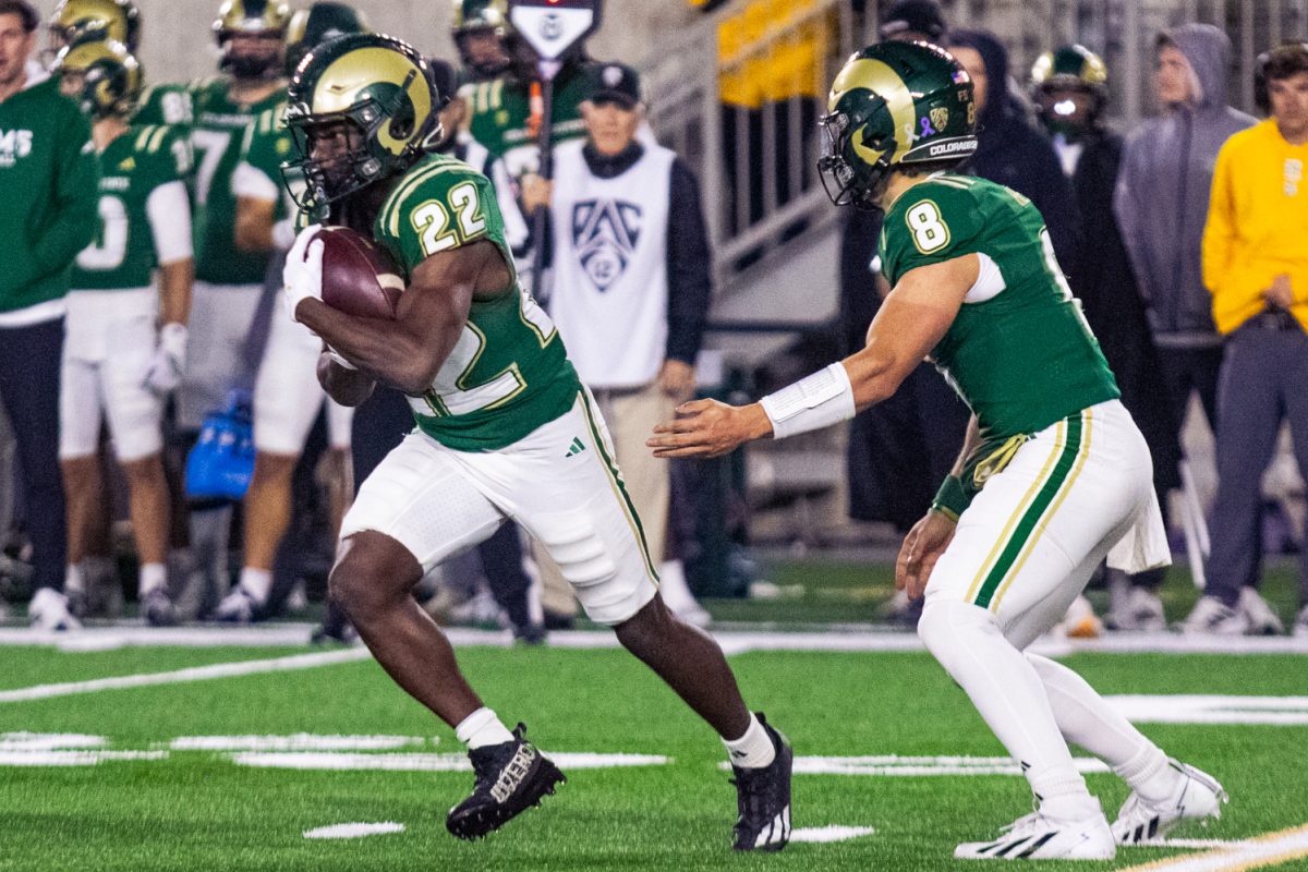 Running back Cedric Ross (22) carries the ball after a hand-off from Hauss Hejny (8) during Colorado State University's home football game against San Diego State University Oct. 24. The Rams rushed for 216 yards against the Aztecs and won the game 56-49.