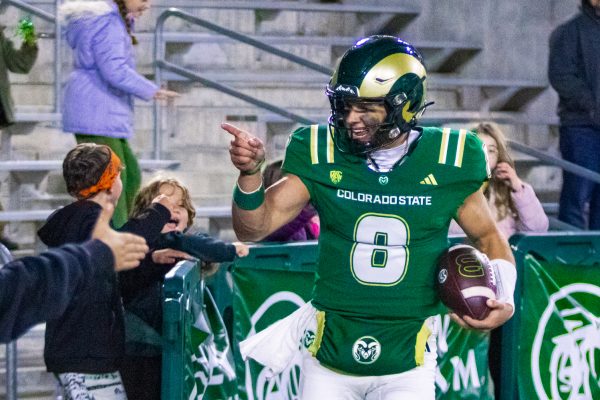Hauss Hejny (8), quarterback for the Colorado State University football team, points at the crowd behind the north end zone in Canvas Stadium after scoring a touchdown against San Diego State University Oct. 24. Hejny threw for 333 yards, including 3 touchdown passes, leading the Rams to a 56-49 victory over the Aztecs.