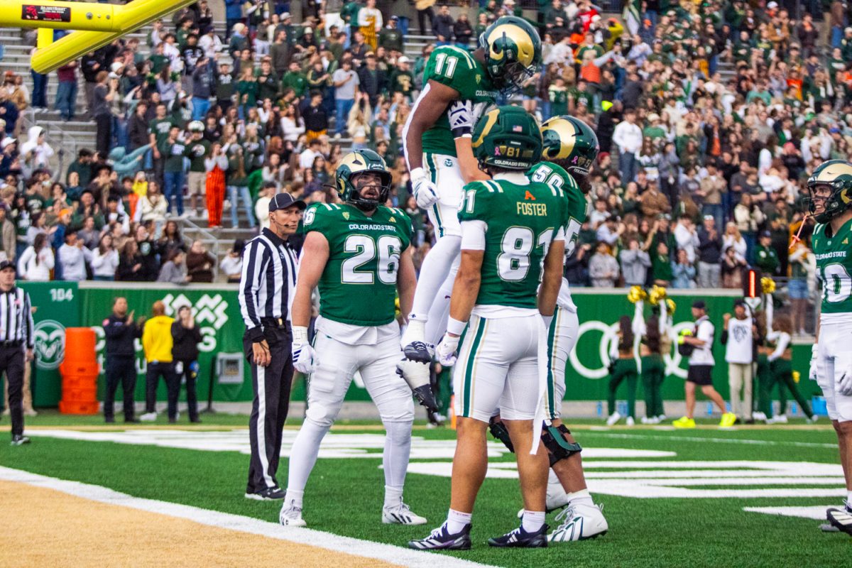 Colorado State Univeristy offensive lineman Jayden Tuia (50) lifts running back Durell Robinson (11) to celebrate Robinson's touchdown during a home game against San Diego State University Oct. 24. Robinson scored two rushing touchdowns for the Rams, contributing to their 56-49 win over the Aztecs.