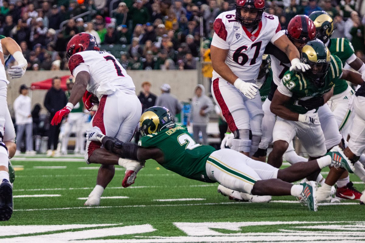 Oumar Diomande (2), a linebacker on the Colorado State University football team, tackles a San Diego State University running back during the first quarter of the Rams' matchup against the Aztecs Oct. 24. Diomande put up 6 tackles and 2 solo tackles in the first half of the game. 
