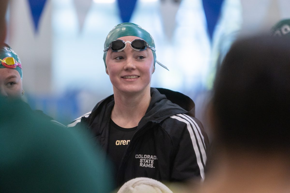 Colorado State University swimmer Evie Munz stands with her teammates during a huddle ahead of CSU swimming and diving's meet against Washington State University and Colorado Mesa University at the Edora Pool Ice Center Oct. 17.